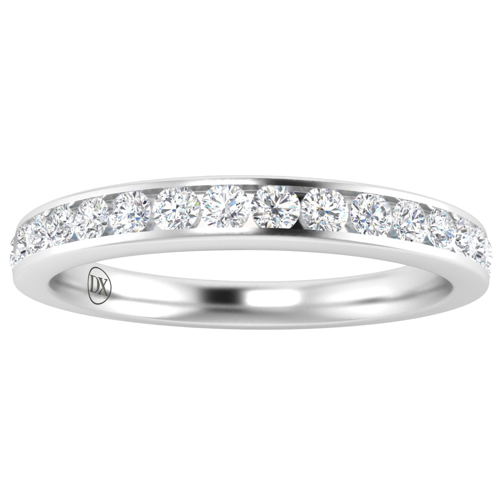 A thin white gold ring set with a row of round, clear diamonds across the top half. The inner band features a small engraved emblem. The design is elegant and minimalist.