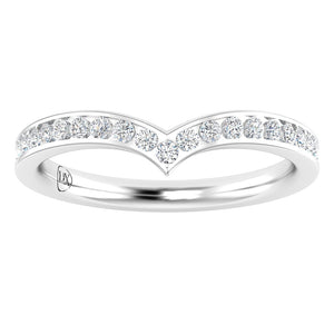 A white gold chevron-shaped ring features a row of round-cut diamonds set along the top, forming a subtle V shape. The inside band has a small engraved mark. The surface is polished and reflective.