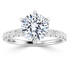 White gold ring with a large round diamond center stone and smaller diamonds on the band.