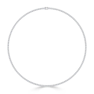 A minimalist necklace, designed as a thin, circular band encrusted with small, evenly spaced diamonds. The necklace has a sleek clasp at the top, adding to its refined and elegant appearance against a plain white background.