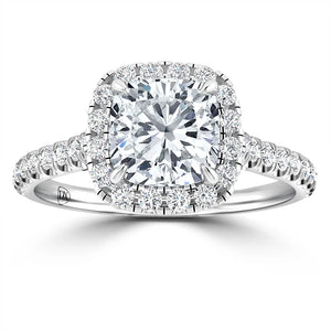 A cushion-cut diamond ring with a halo setting and a diamond-encrusted band, shown on a white background.