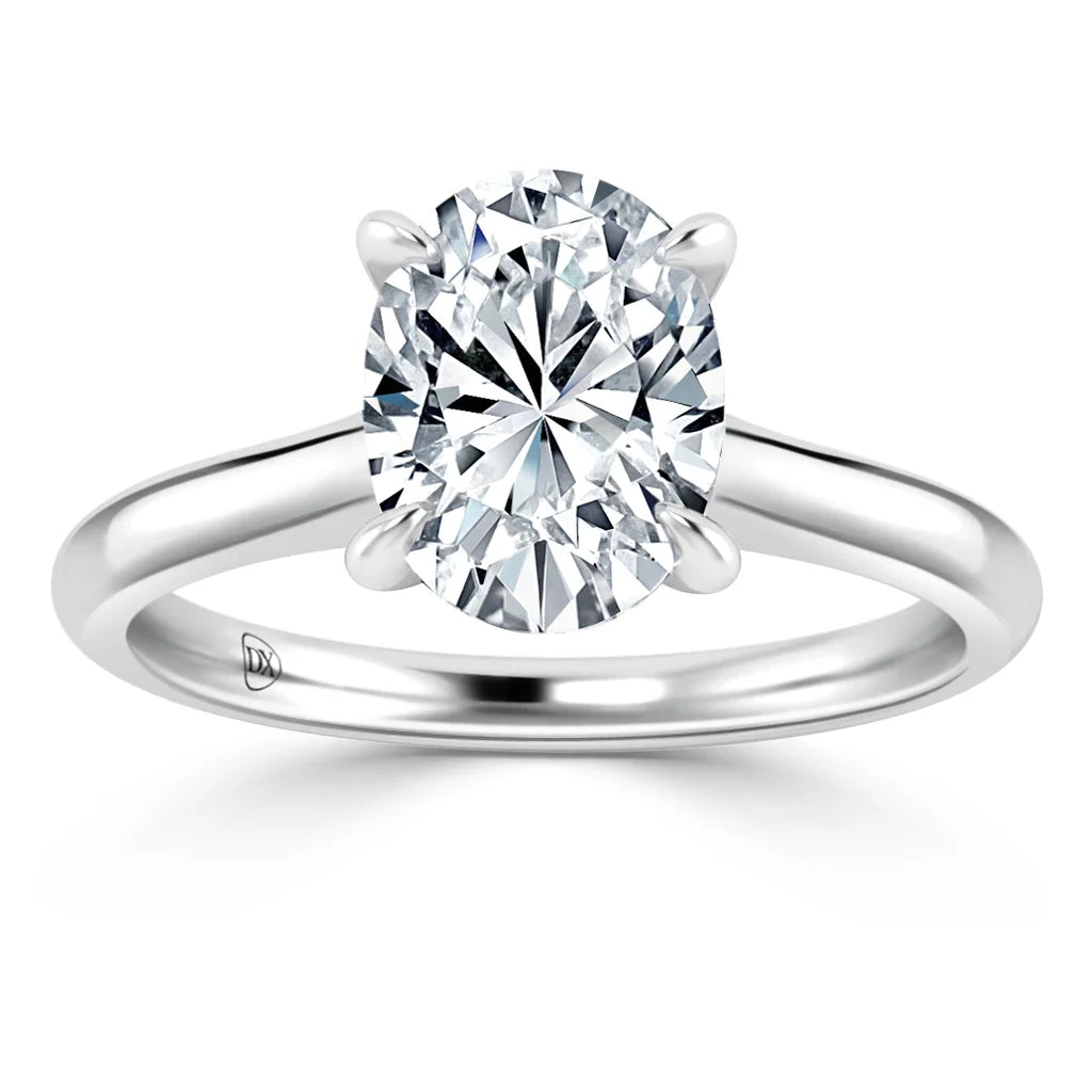 A solitaire diamond ring with an oval-cut diamond set on a simple, polished white gold band.