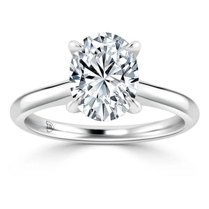 A solitaire diamond ring with an oval-cut diamond set on a simple, polished white gold band.